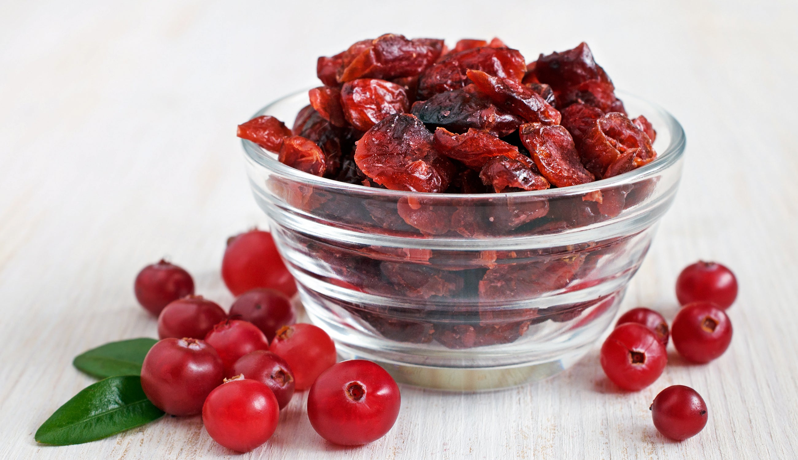 Dehydrated and fresh cranberries in a glass bowl