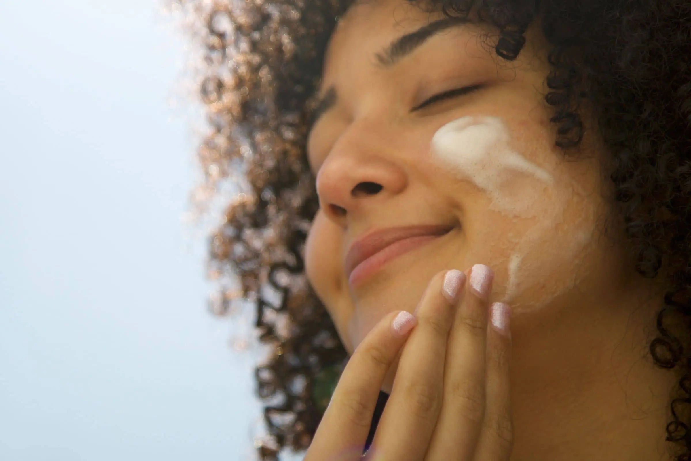 Woman Using Moisturizer